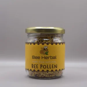 Bee pollen granules in glass jar with wooden spoon on rustic wooden table in natural setting